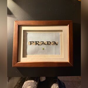 Prada Logo Cross-Stitch in Wooden Frame